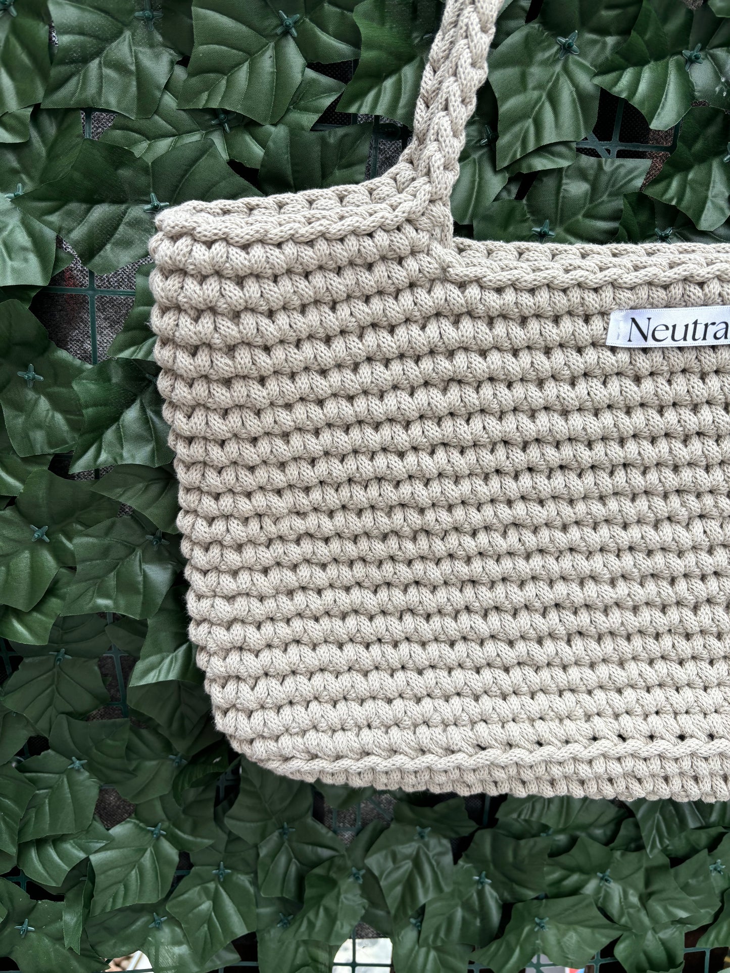 close up of beige large crochet beach bag