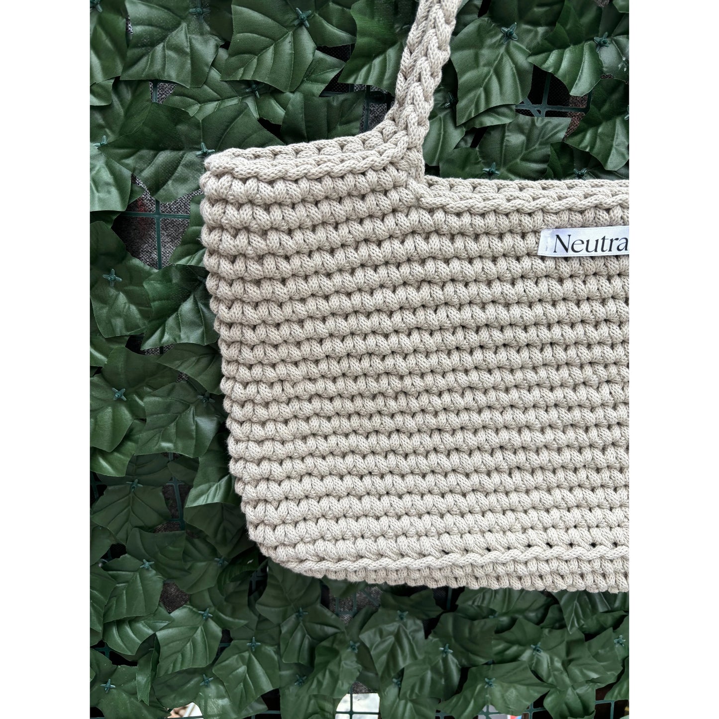 close up of beige large crochet beach bag