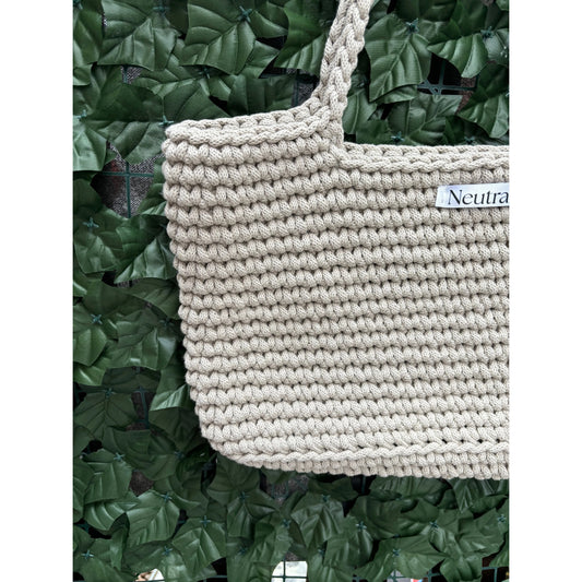close up of beige large crochet beach bag