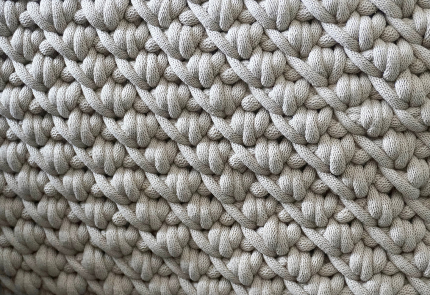 Extra close up of the pattern of the moses baskets in beige