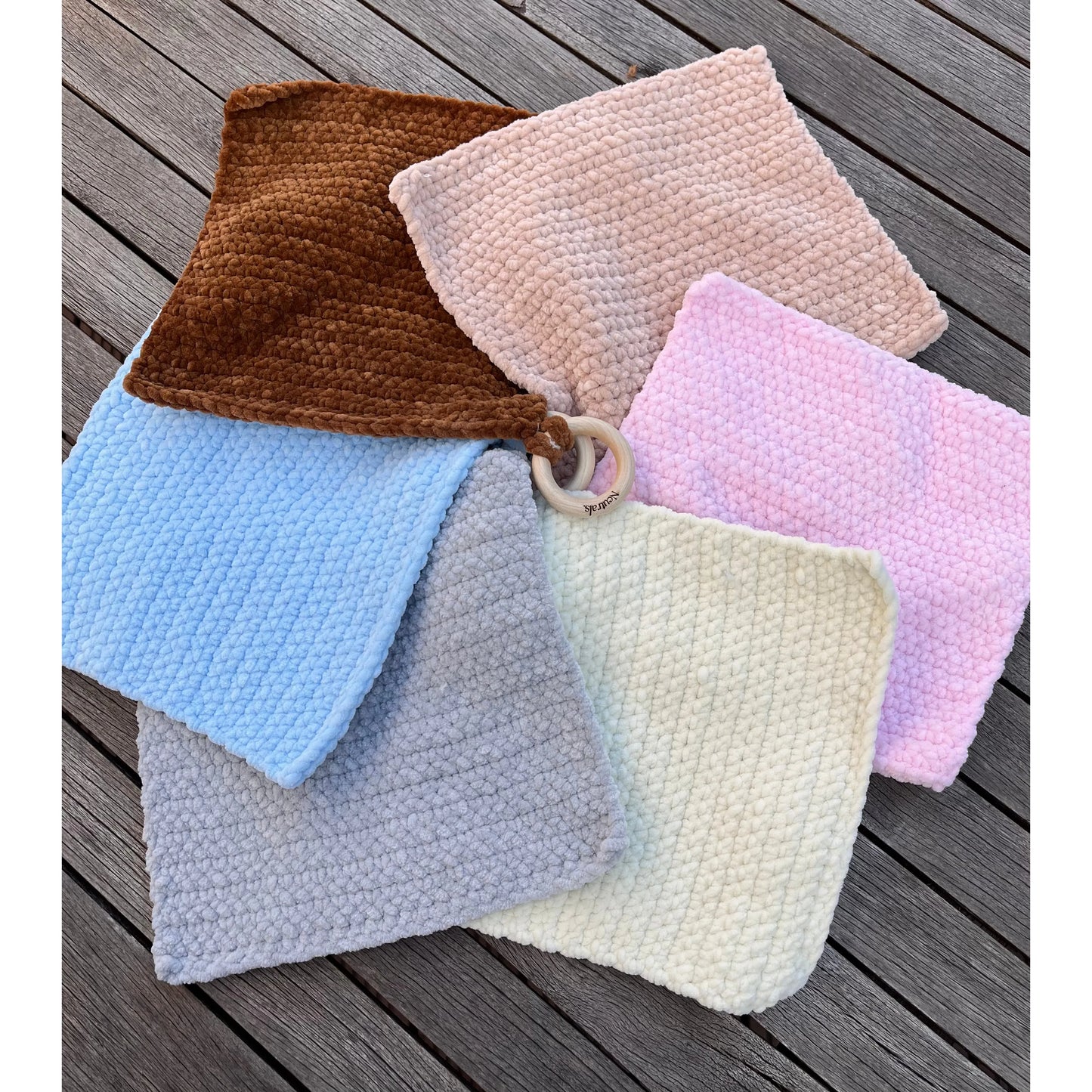 all the comforters in a circle so you can see more of the colours and the wooden loops