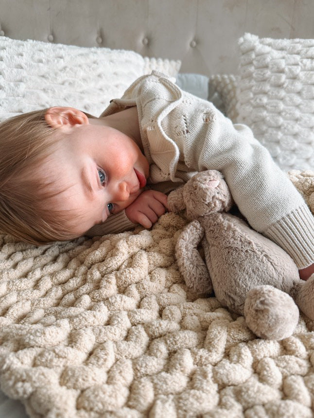 Baby laid on her super chunky blanket all cosy neutral colour crochet 