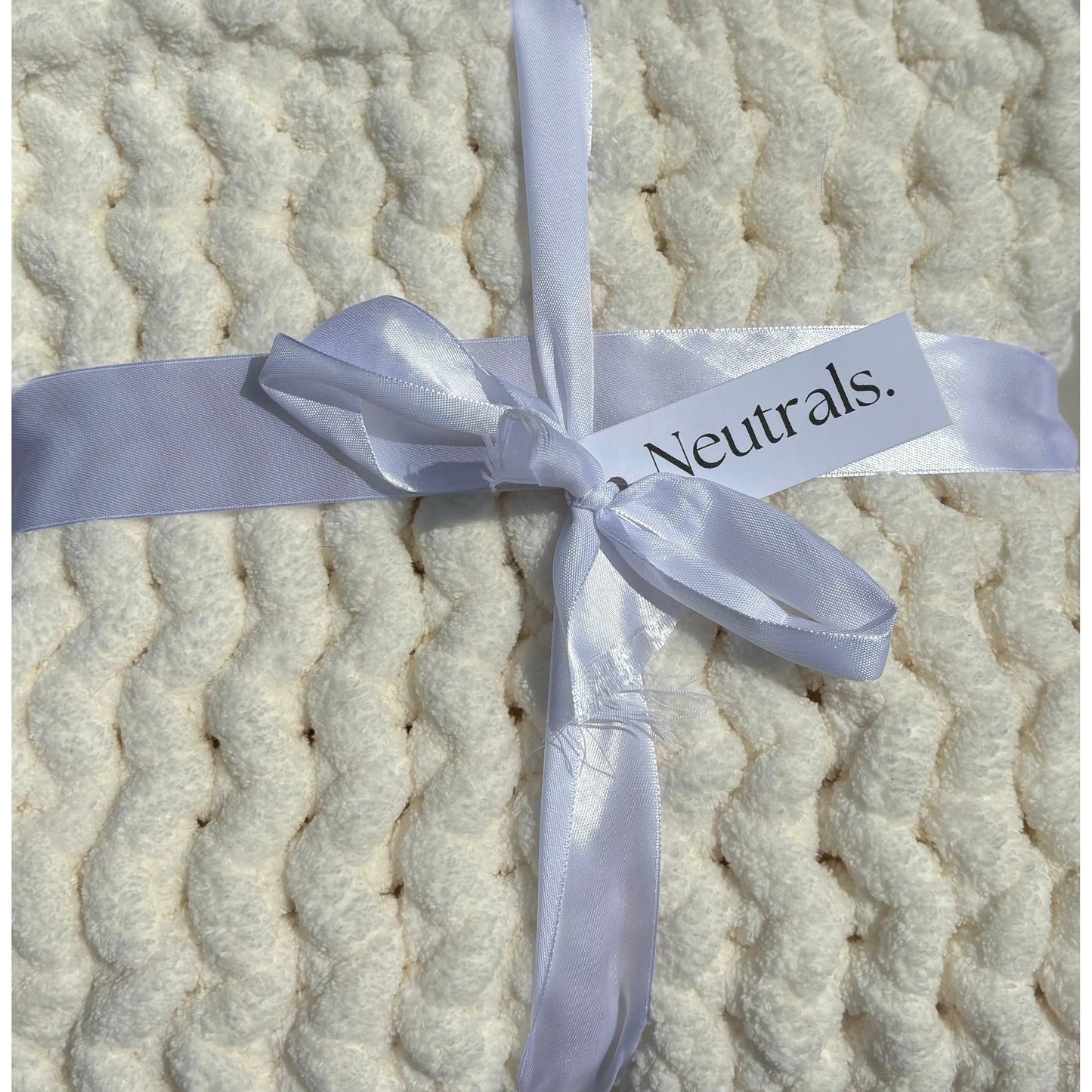 Close up of the cream super chunky blanket