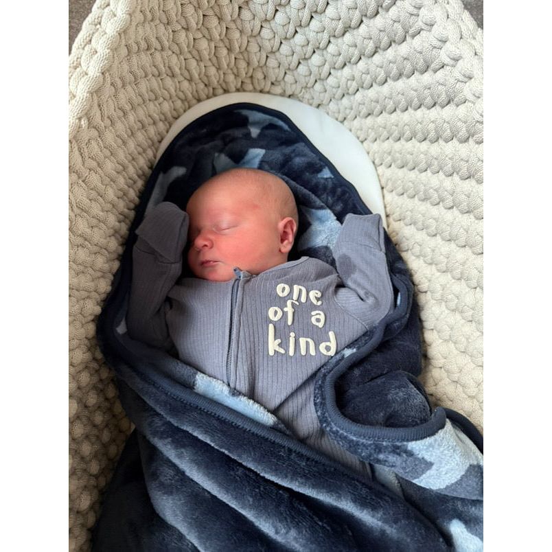 Baby inside the beige moses basket 