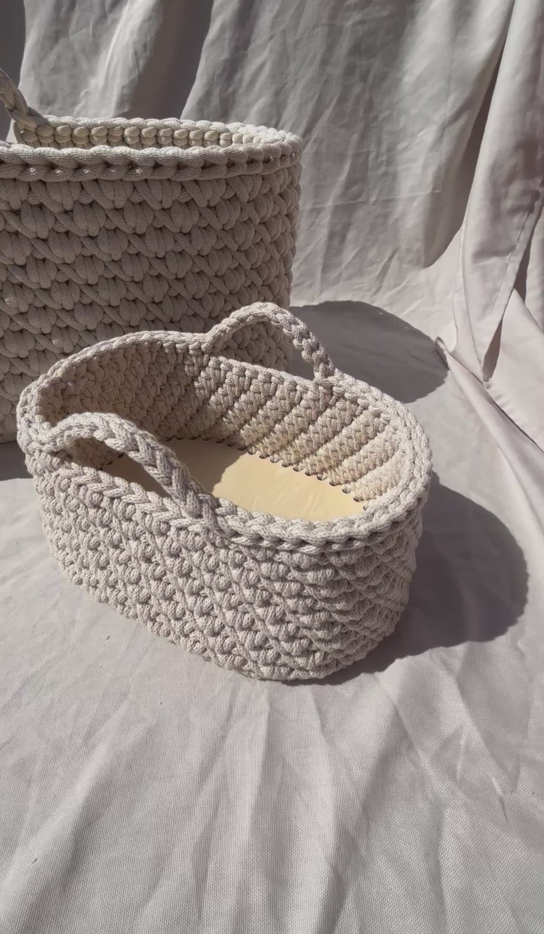 close up video of the moses basket and nappy caddy in the sun on a neutral background